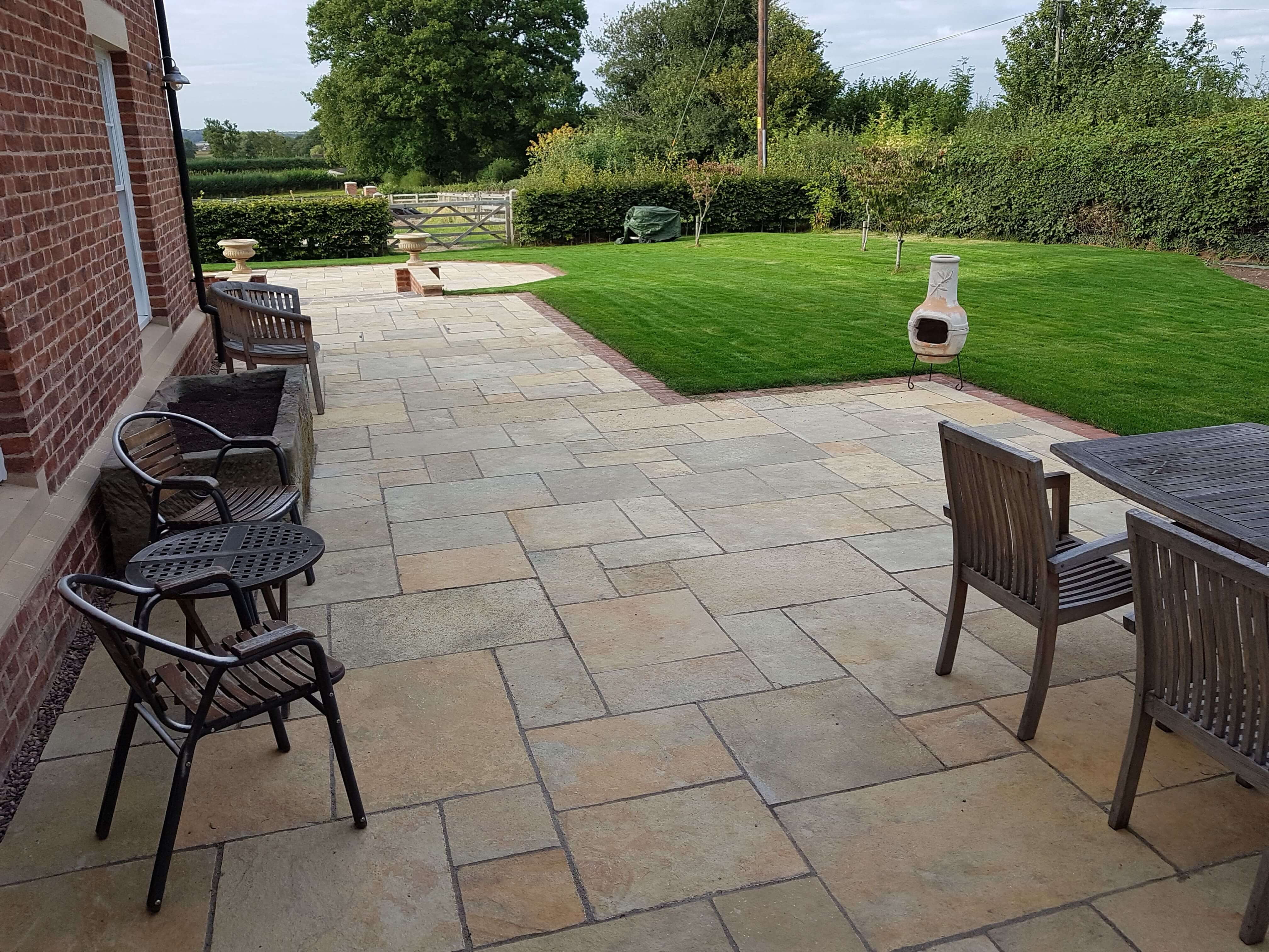 Natural stone patio with outdoor seating and countryside views