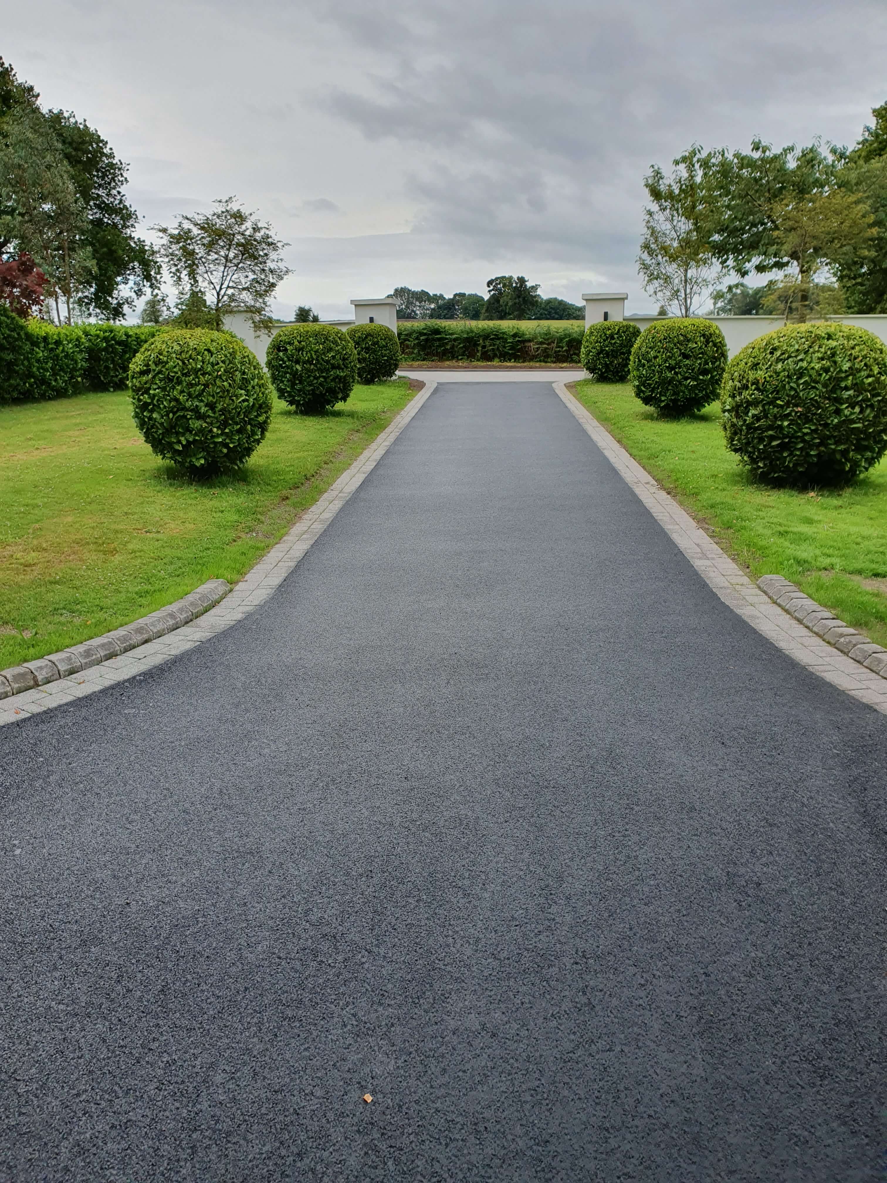 Tarmac driveway with manicured topiary hedging