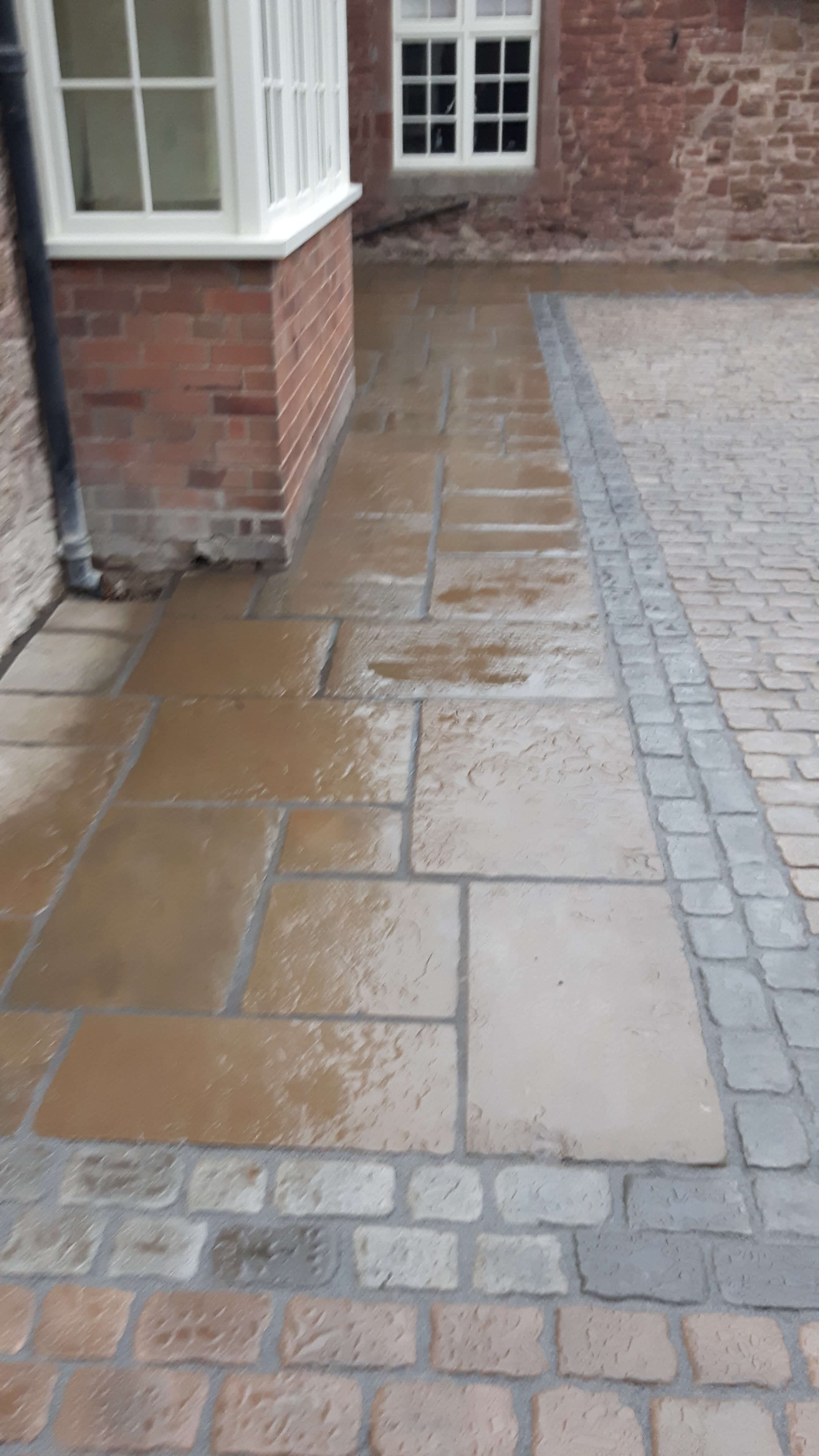 Natural stone paving with cobblestone border detail