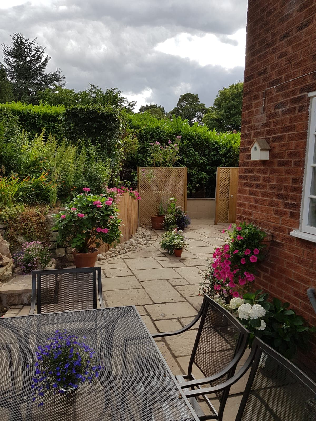 Cottage garden patio with flowering borders